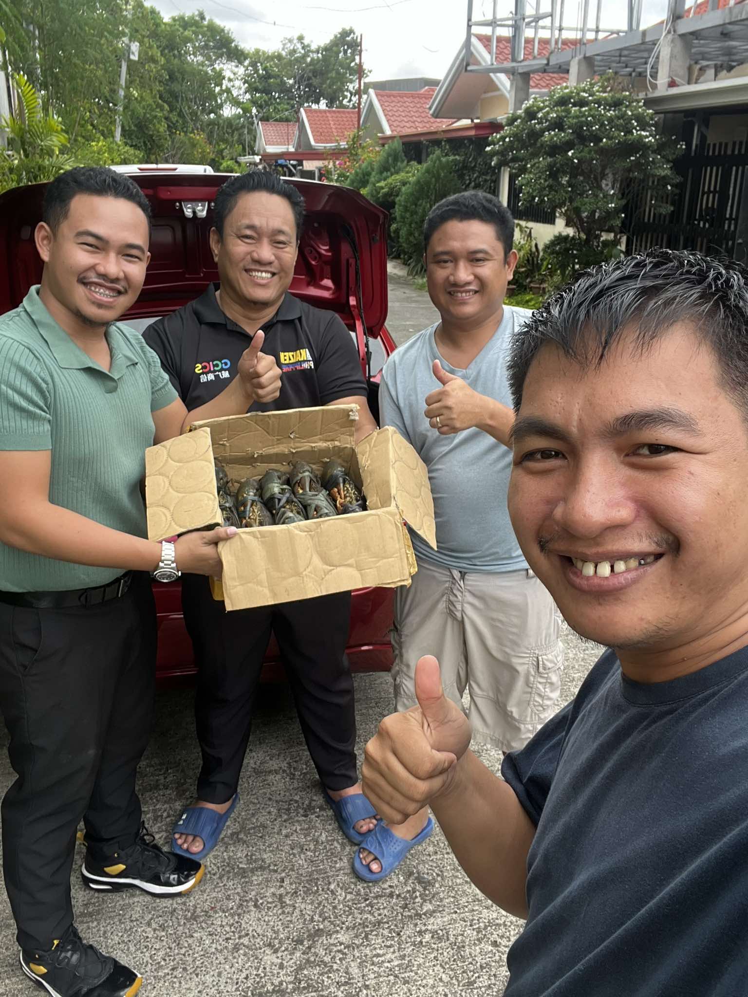 People showcasing fresh crabs from Big Byte Aquaventures with cheerful approval.