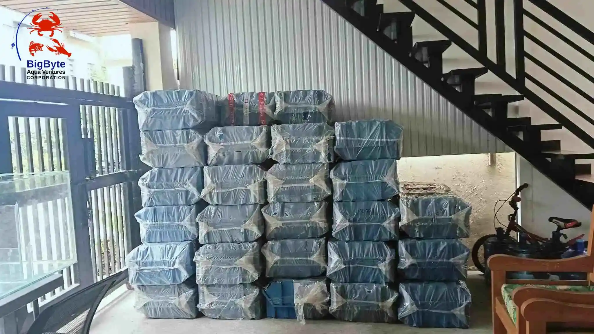 Stack of BigByte Aquaventures vertical crab farming boxes neatly stored inside the facility.