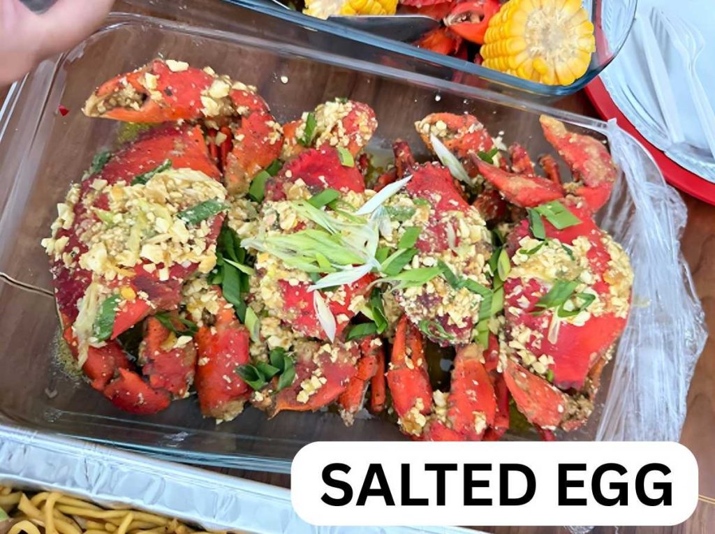 Freshly cooked salted egg crab with thick golden sauce and red chili garnish