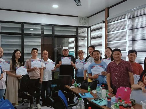 Seminar participants proudly holding certificates.
